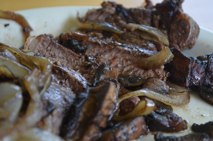 steak cut up with mushrooms and onions